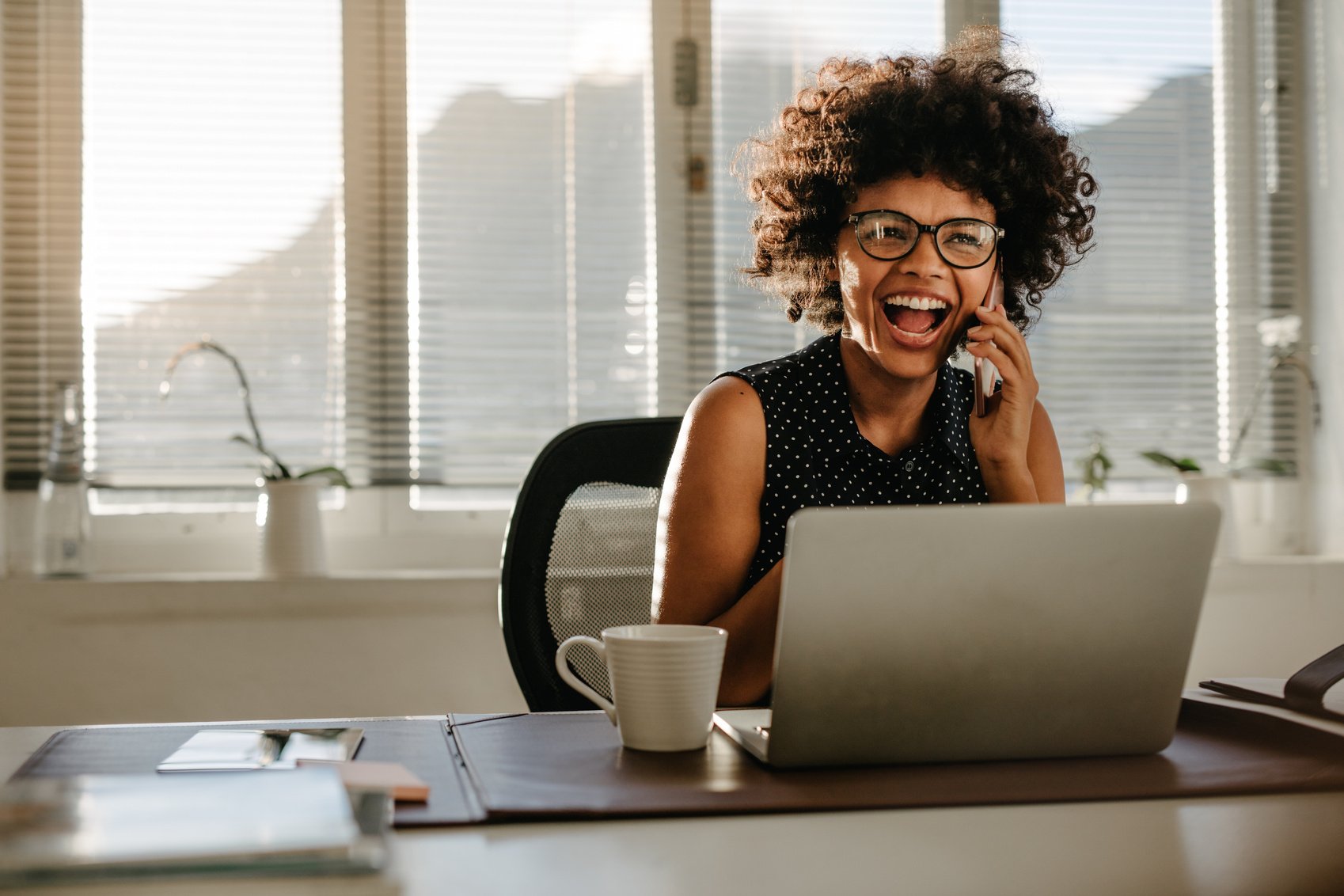 Businesswoman Talking on Phone and Laughing